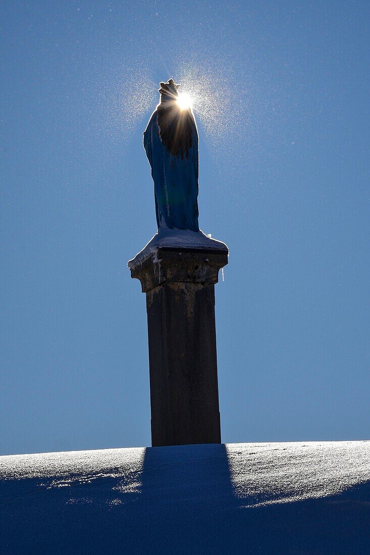 Frankreich, Jura, GTJ, große Juradurchquerung auf Schneeschuhen, eine Statue der Jungfrau beherrscht das Dorf la Pesse unter dem Schnee