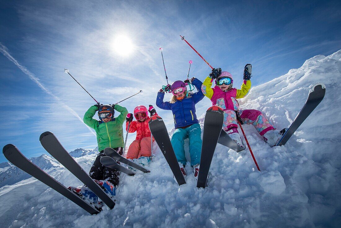 France, Haute Savoie, Massif of the Mont Blanc, the Contamines Montjoie, groups of children sat in the snow raises their sticks on ski runs