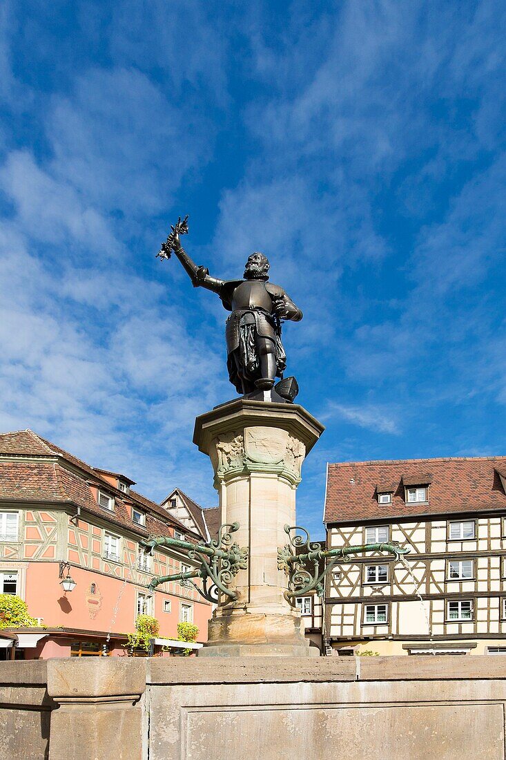 France, Haut Rhin, Route des Vins d'Alsace, Colmar, fountain by Frederic Auguste Bartholdi dedicated to Lazare de Schwendi and facade of a half timbered house on the former custom office square (Koifhus)