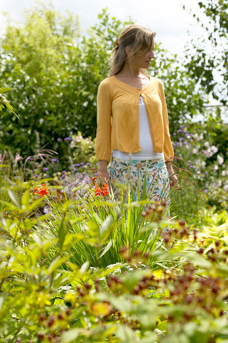 Woman walking in summer garden