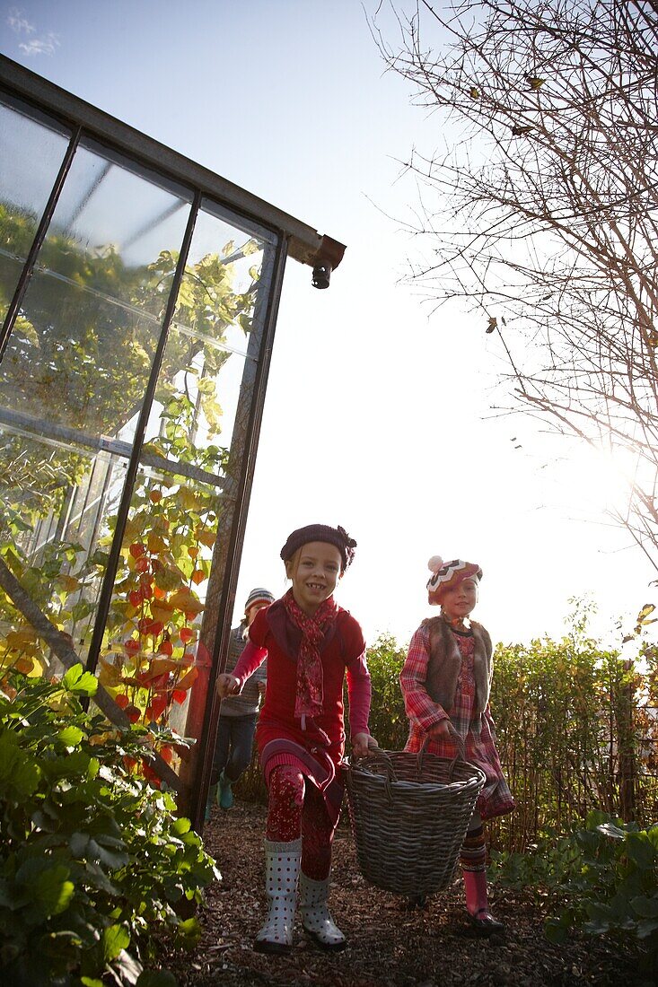 Kinder gehen den Gartenweg hinunter