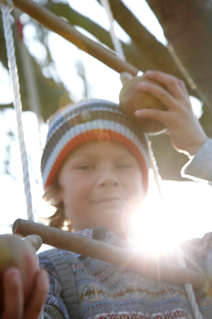 Boy on swing ladder