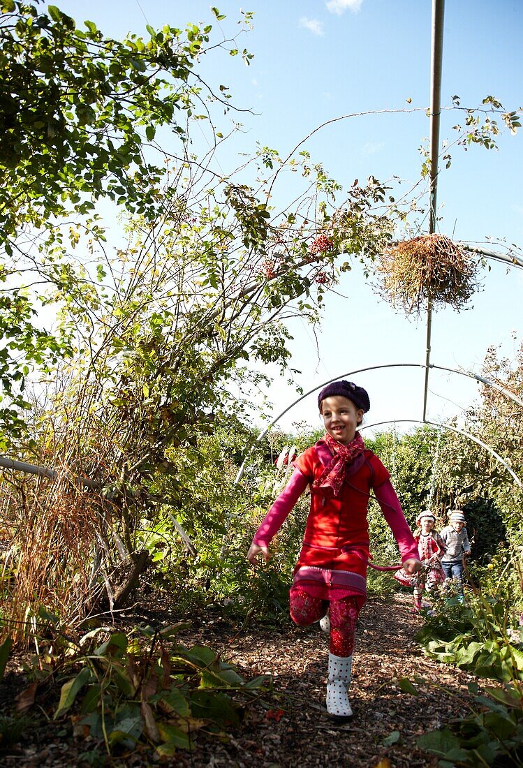 Children running down garden path