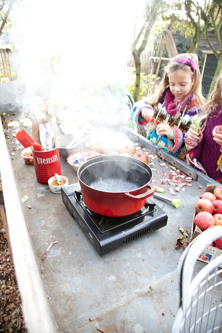 Children making apple sauce