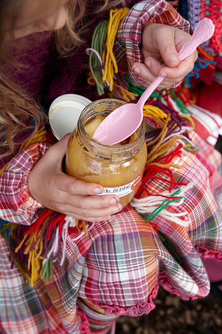 Girl eating apple sauce