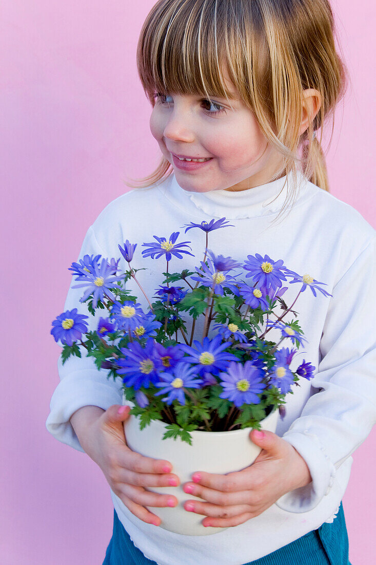 Girl holding anemone blanda