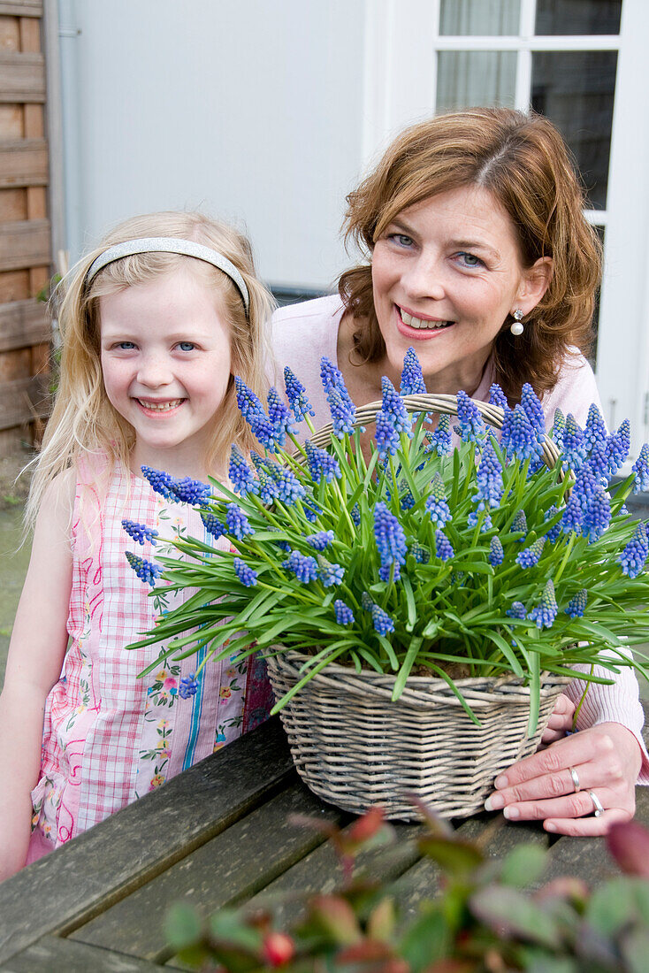 Mother and daughter holding Muscari
