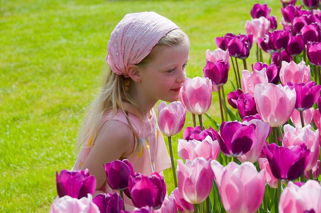Girl smelling tulips
