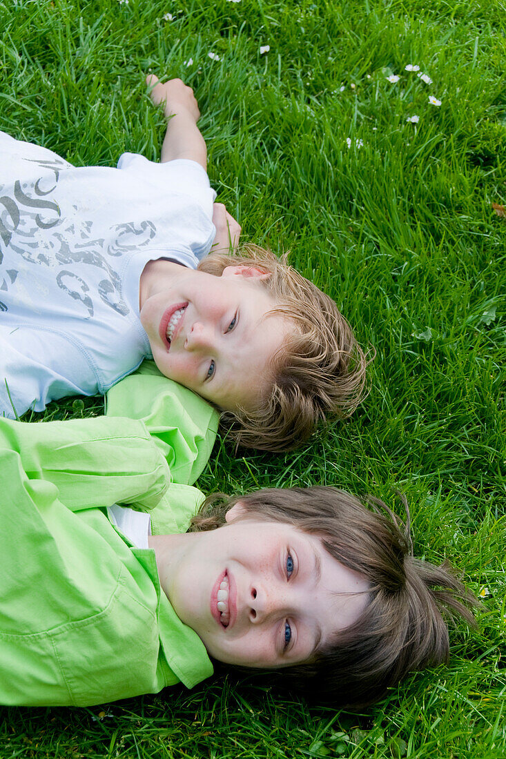 Children lying on grass