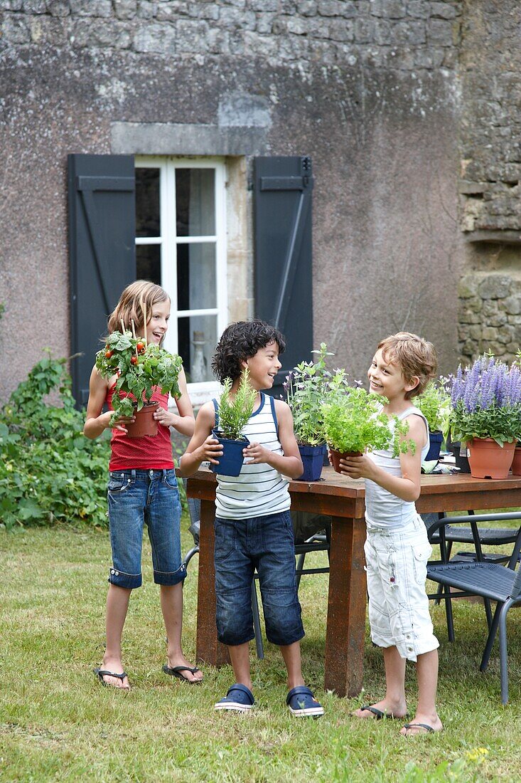 Children with vegetable plants