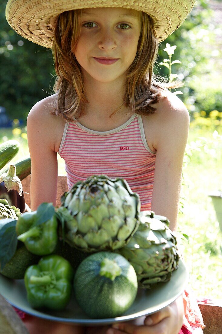 Girl holding vegetables