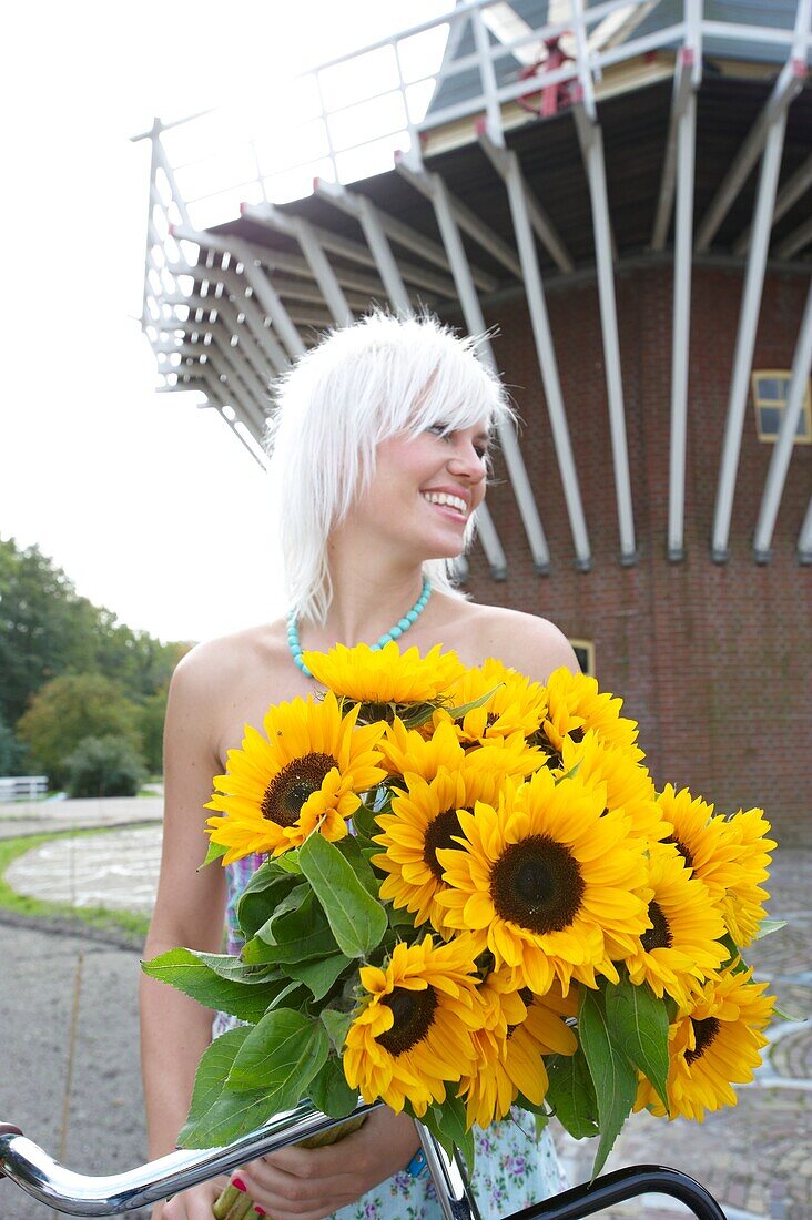 Woman holding sunflowers