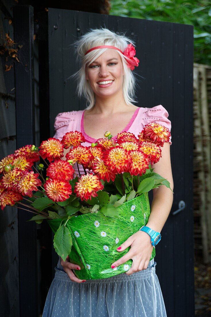 Woman holding dahlias