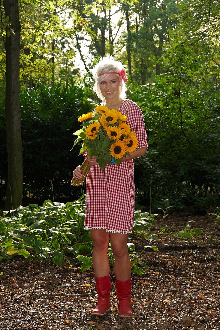 Woman holding sunflowers