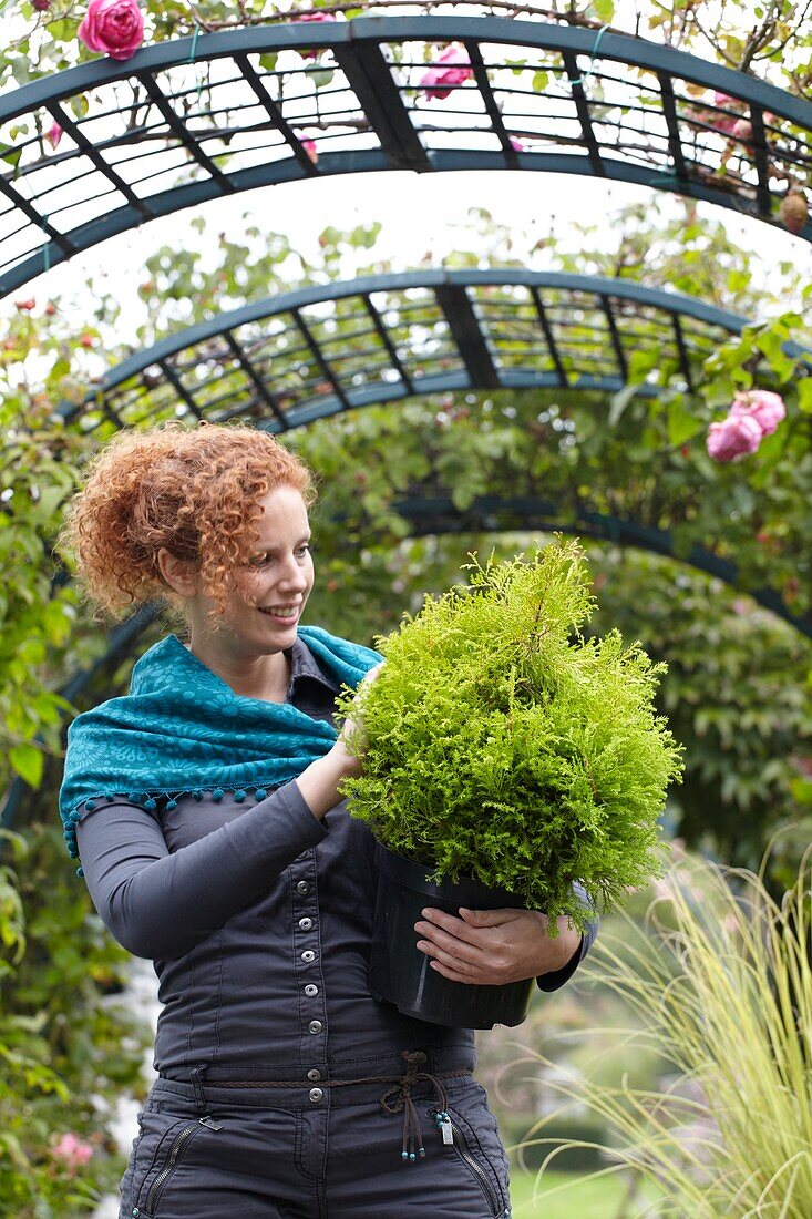 Woman holding conifer