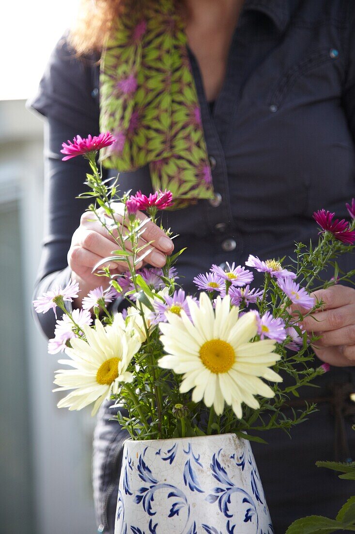 Woman arranging autumn flowers