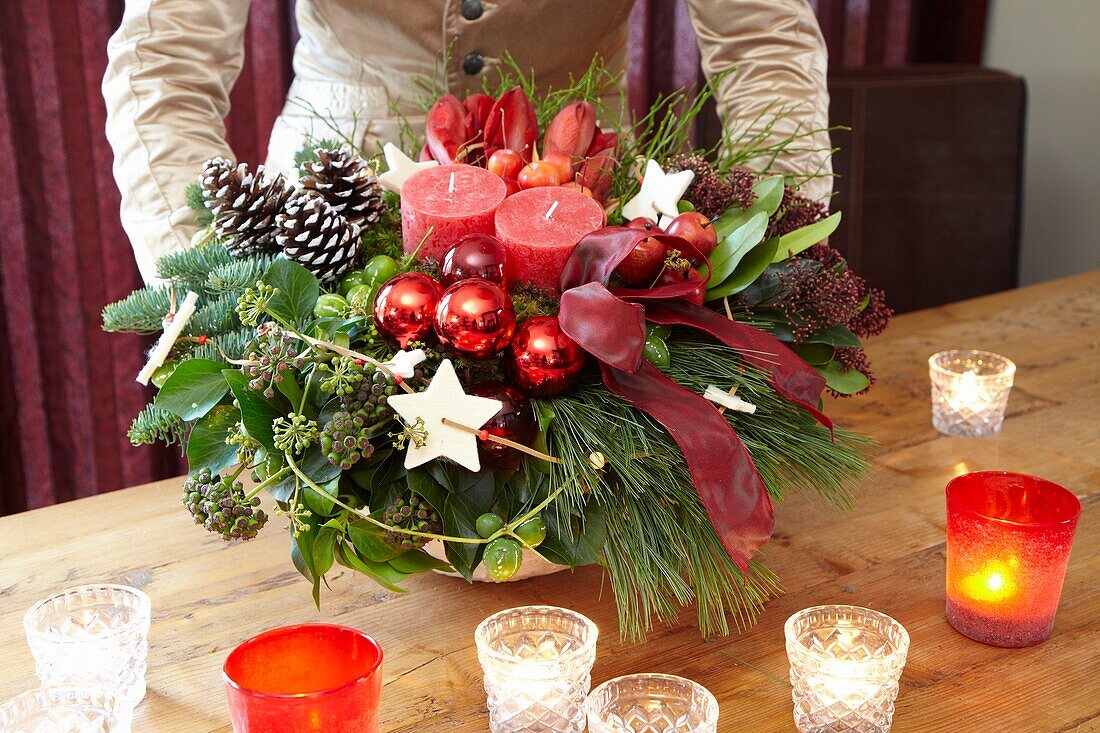 Florist holding christmas arrangement