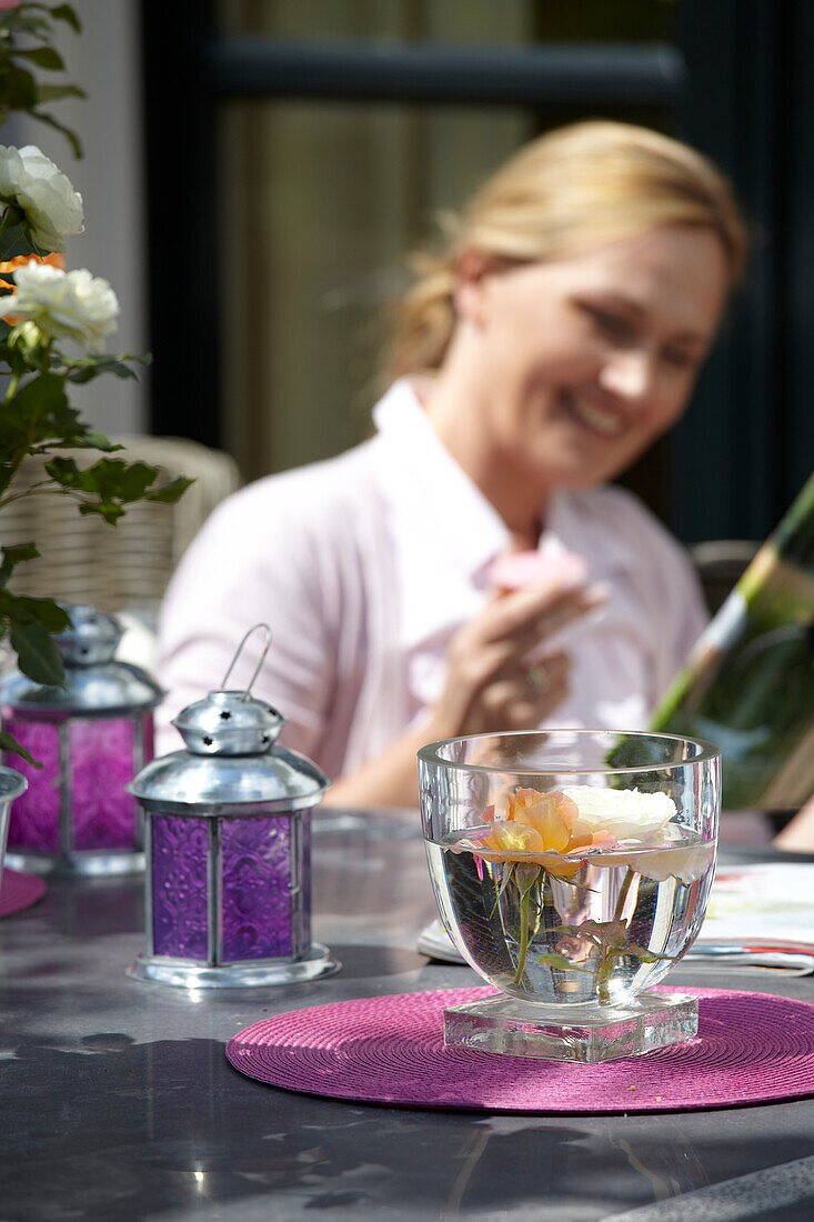 Woman reading at garden table