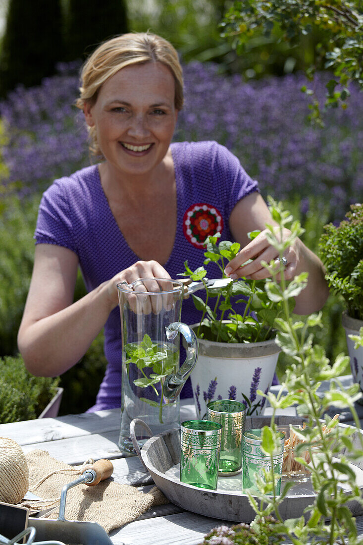 Woman gardening with herbs