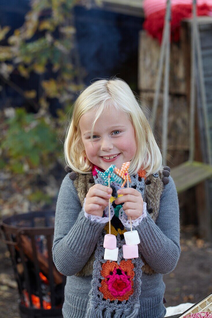Girl with marshmallow skewers