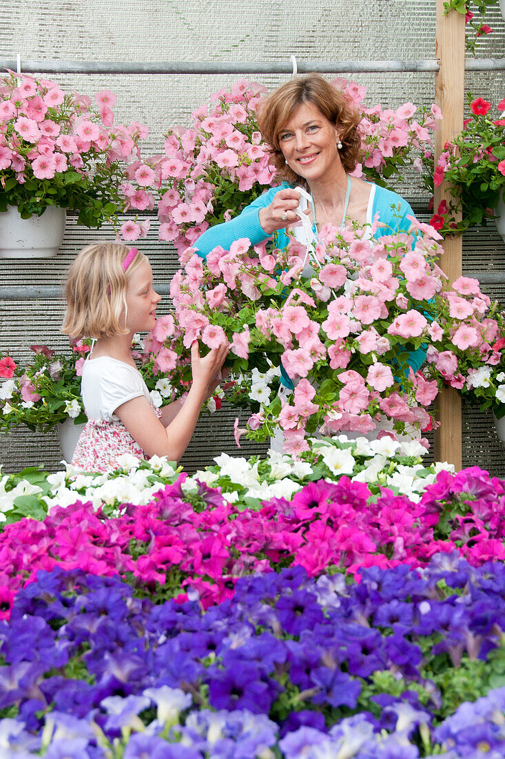 Woman buying plants in garden center