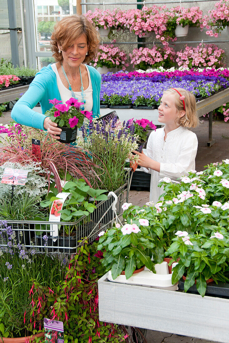 Woman buying plants in garden center