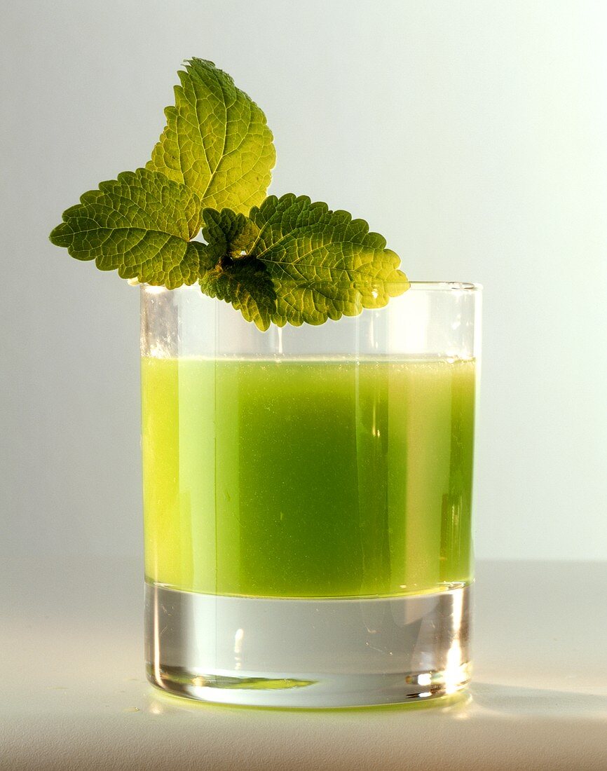 Lemon balm juice in glass, decorated with lemon balm leaves