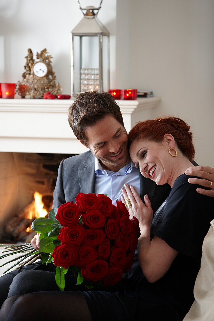 Couple holding red roses