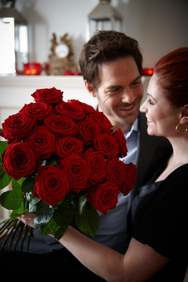 Couple holding red roses