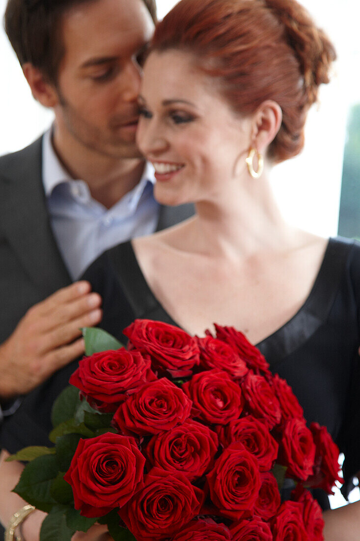 Couple holding red roses