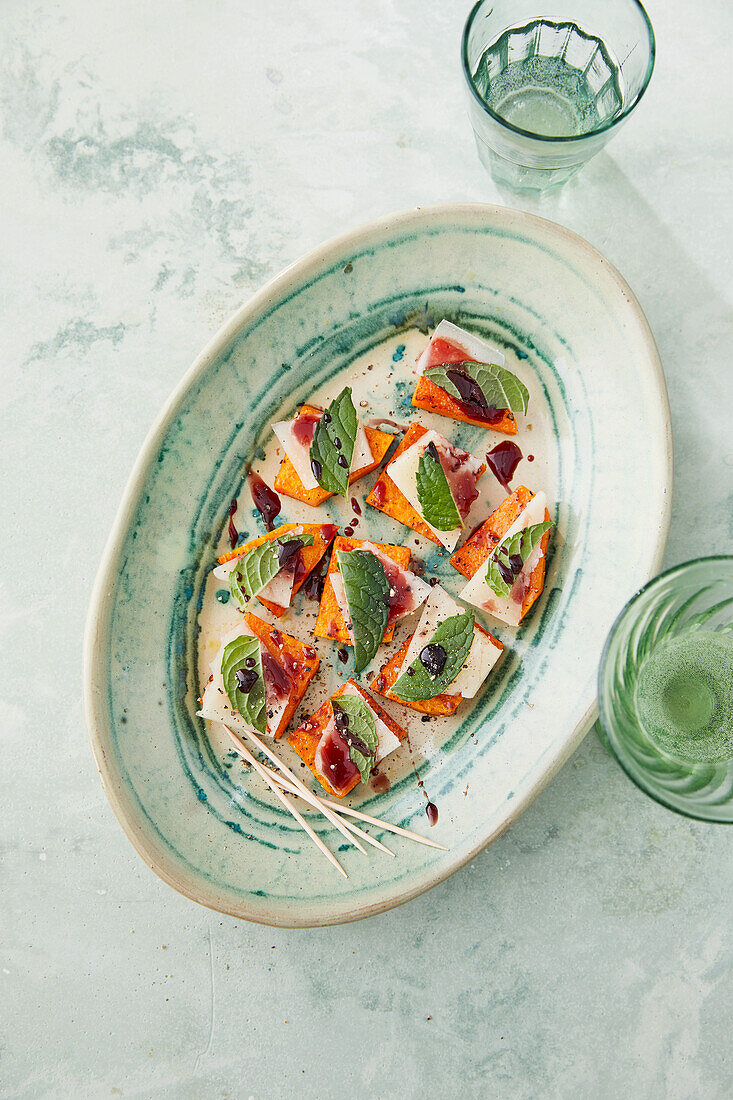 Pumpkin canapés topped with pecorino and mint