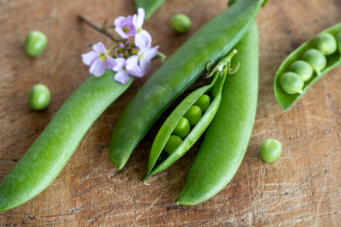Fresh peas and pods on a wooden table
