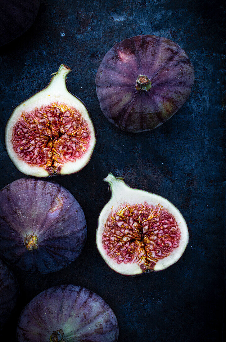Whole and half figs on a blue-metallic background