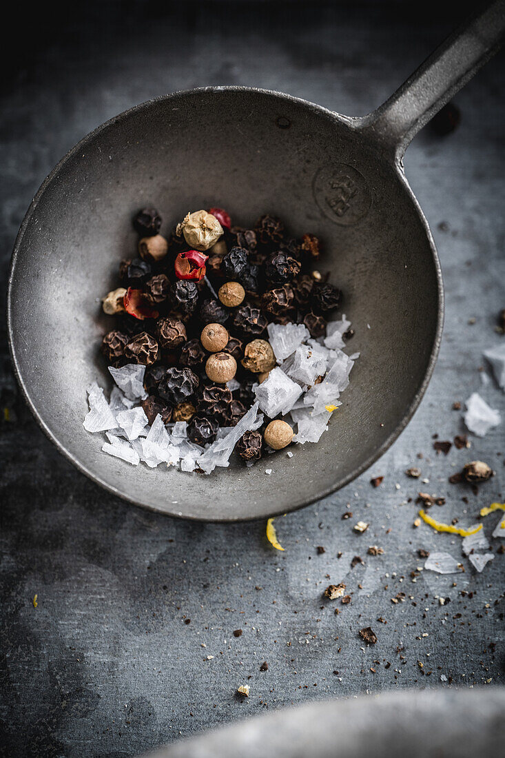 Colourful pepper and Maldon salt on a metal spoon