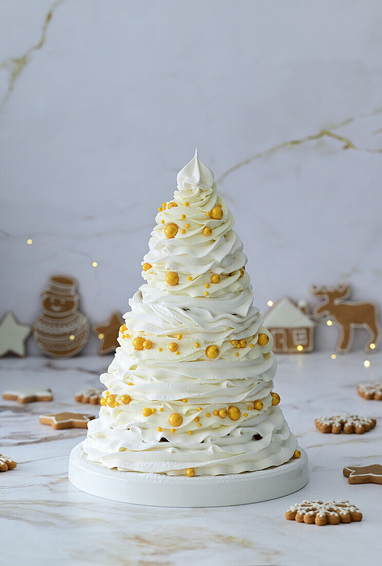Four-tier pavlova cake with berry filling and mascarpone cream in the shape of a Christmas tree