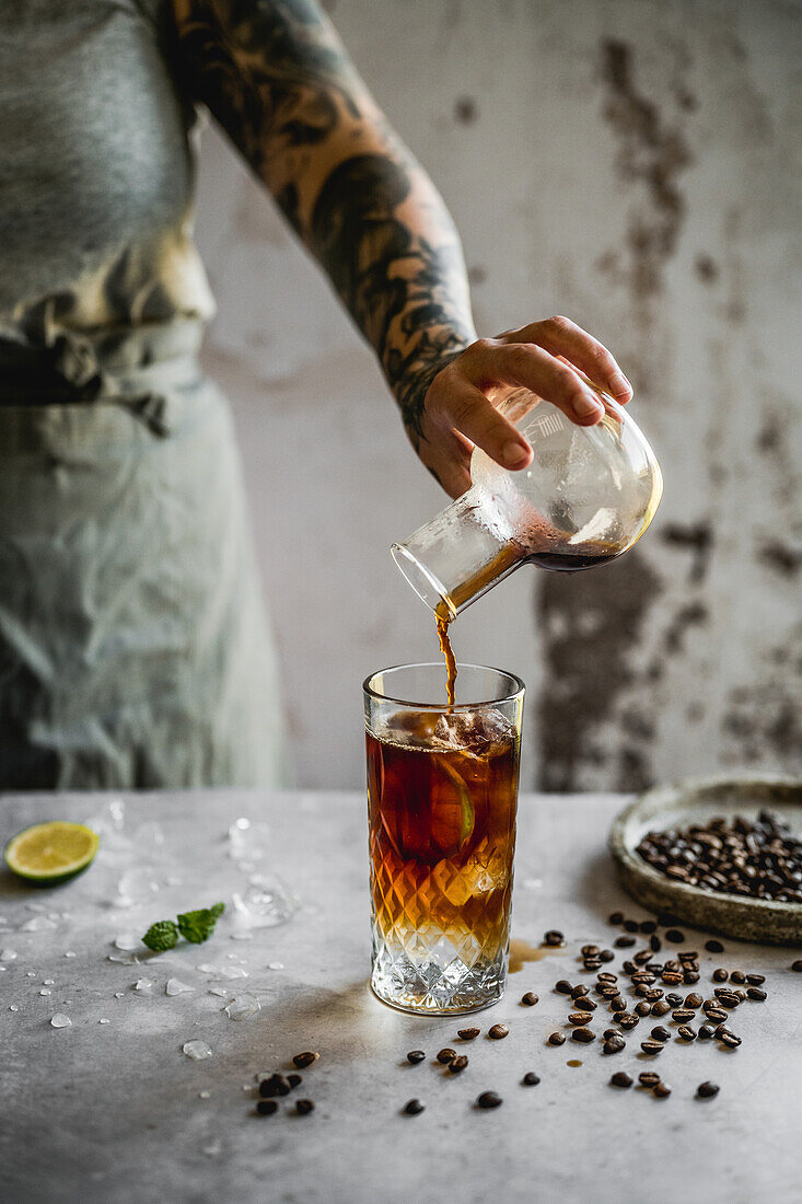 Espresso tonic with lime and ice cubes