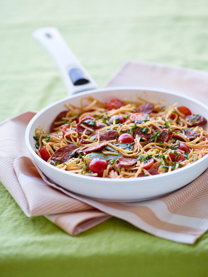 Pasta pan with cherry tomatoes and salami