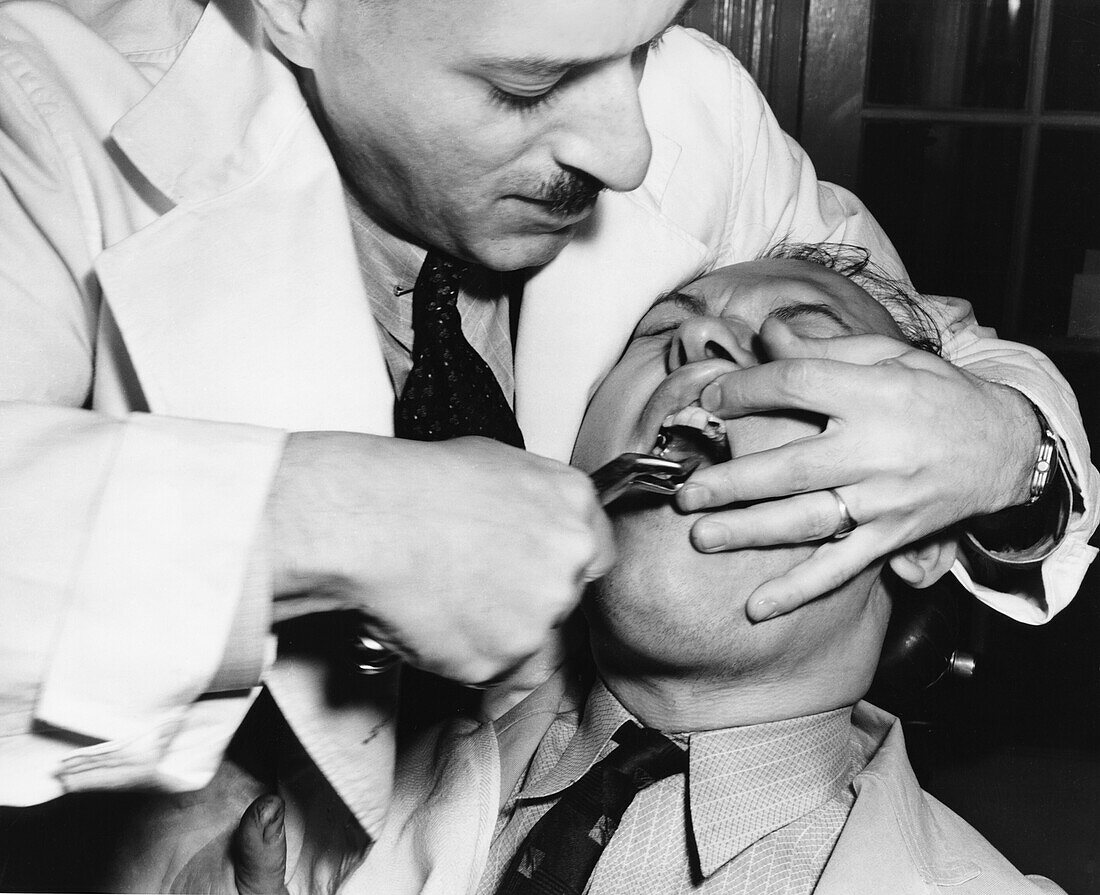 Patient having tooth extracted, 1930s