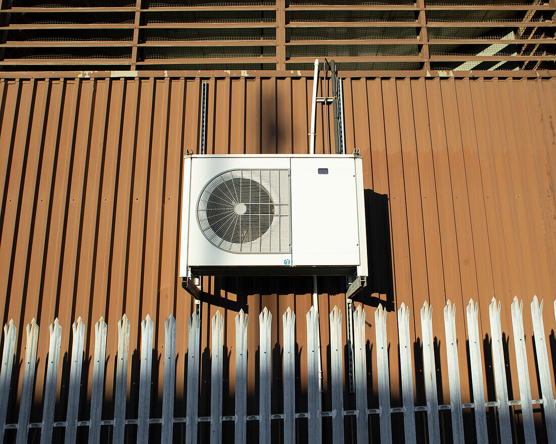 Air conditioning condenser unit on side of factory