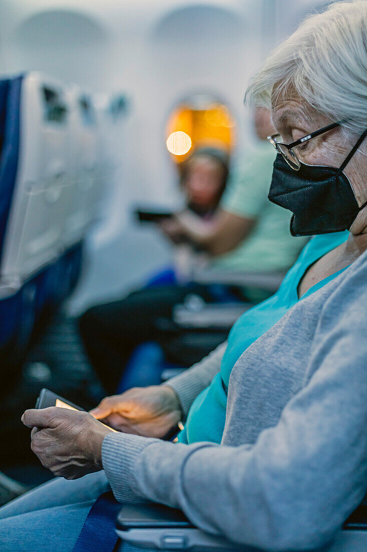 Passenger using e-reader on flight