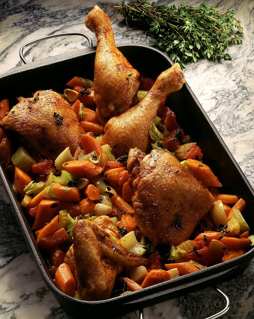 Chicken in carrots & celery in a roasting dish