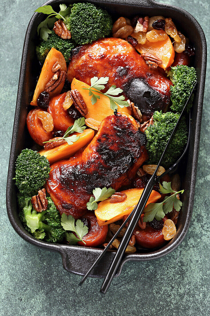Roasted chicken thighs with broccoli, persimmon and dried fruit