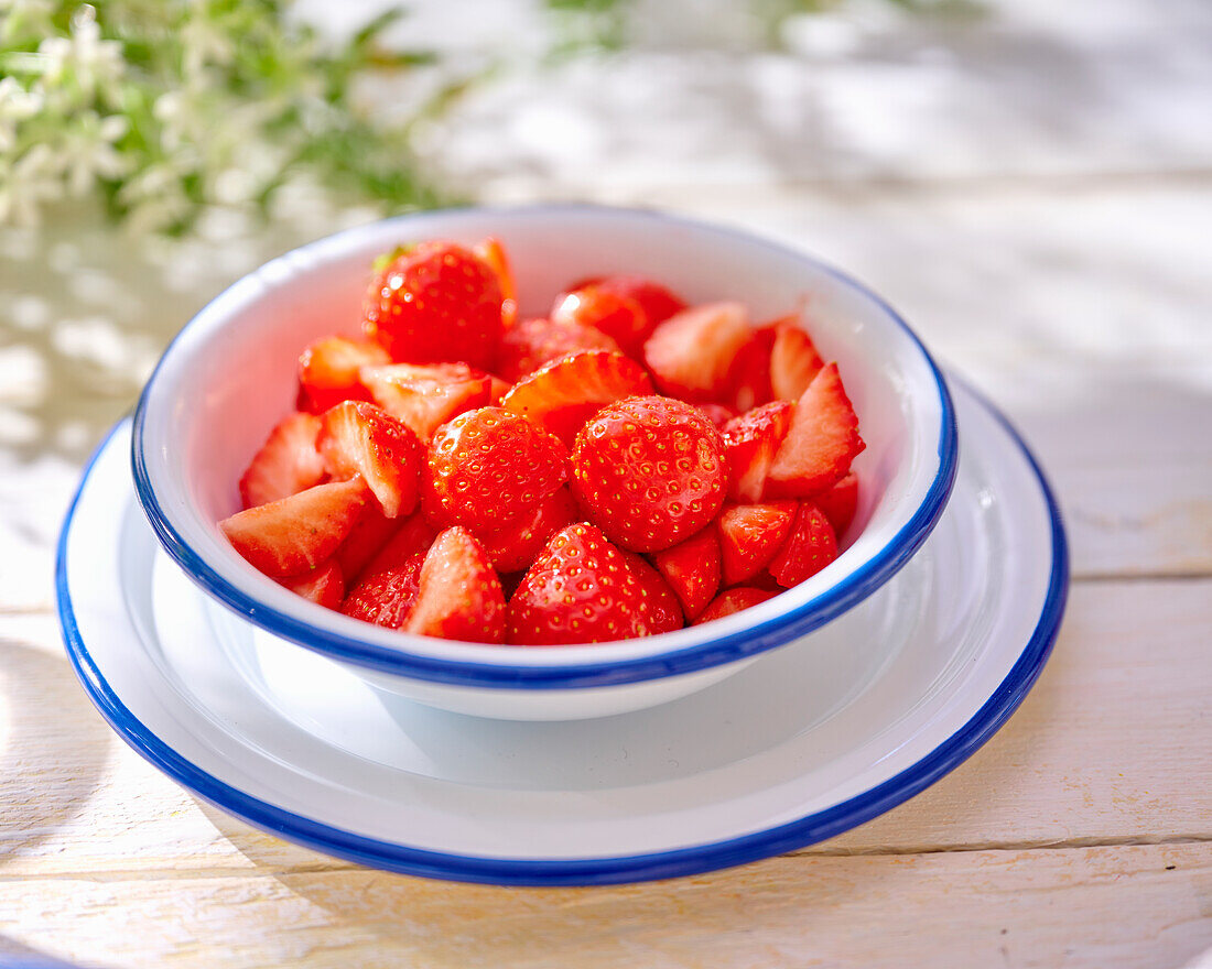 Sliced strawberries in small bowls