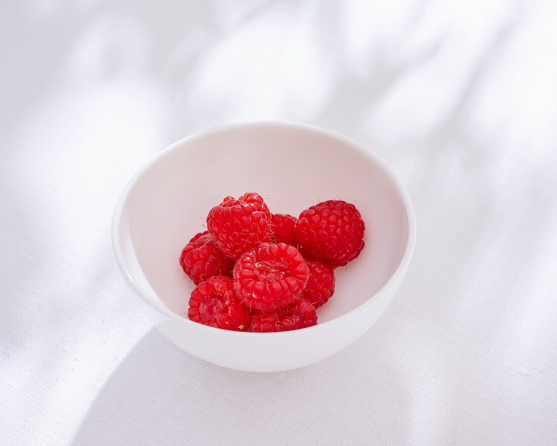 Raspberries in porcelain bowls