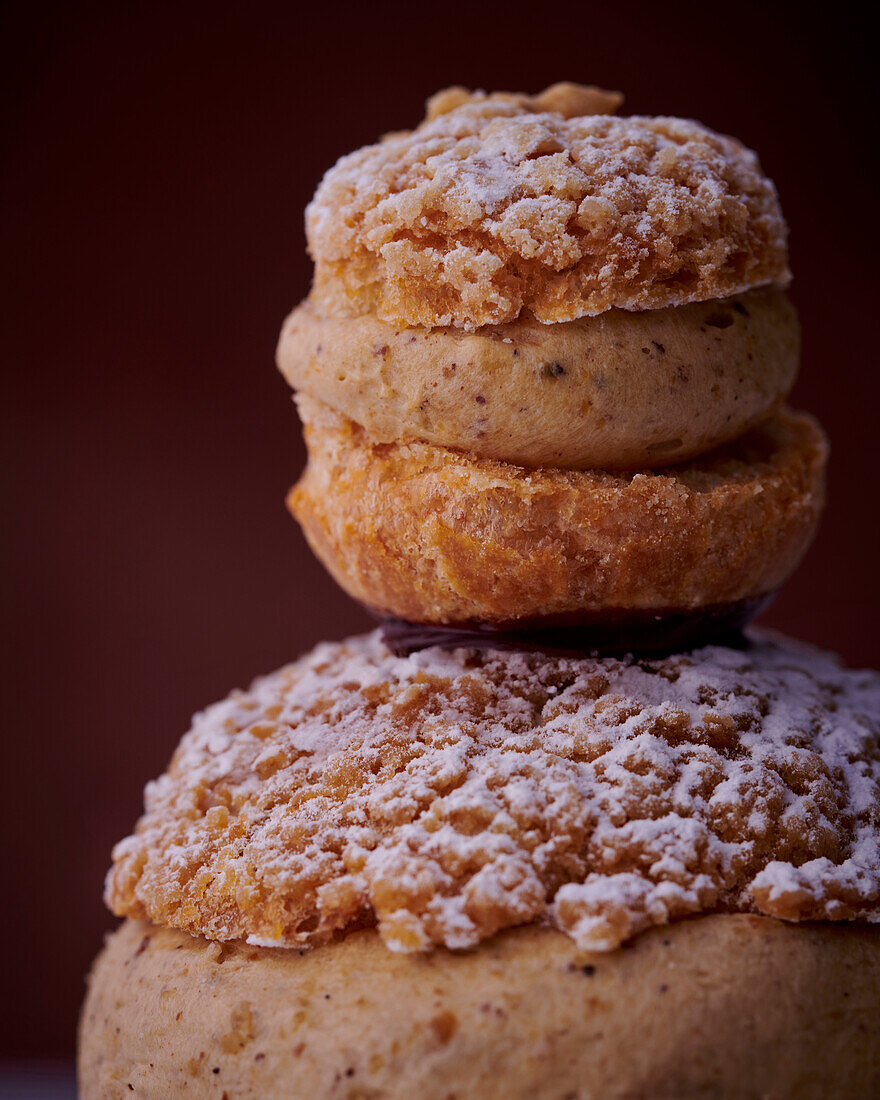 Two different sized Religieuses with nut cream and crumble