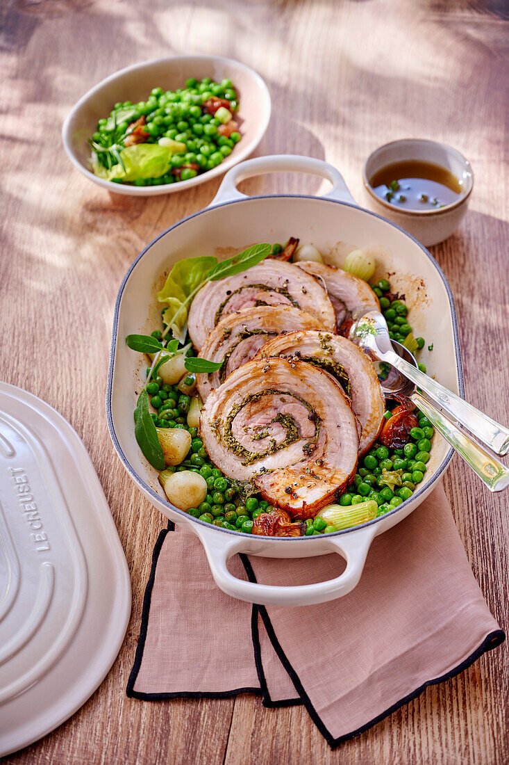 Pork belly roulade with herb filling and pea vegetables