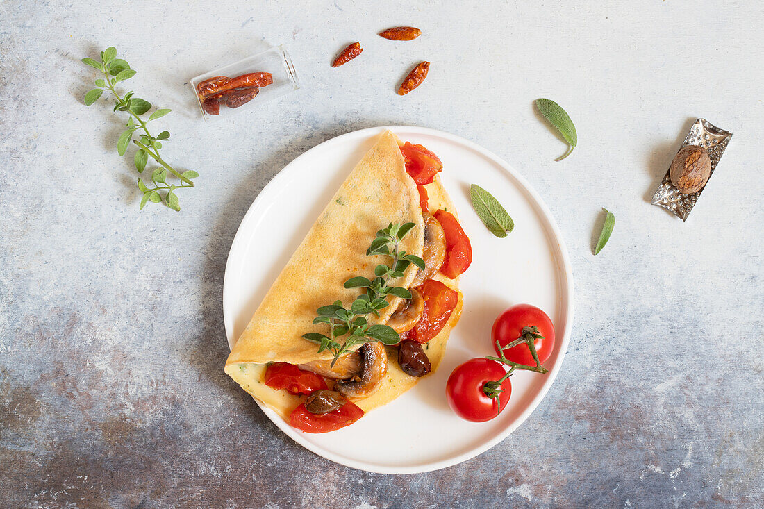 Flavoured herb crêpes with tomatoes, mushrooms and olives