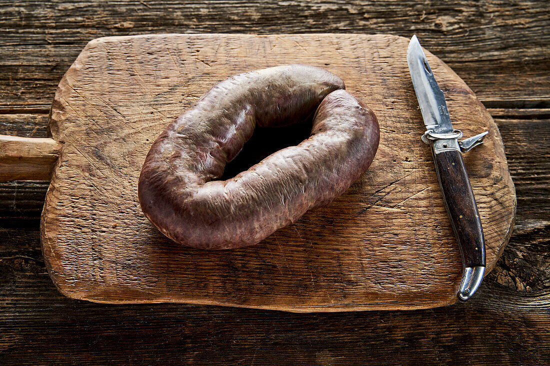 Black pudding with grated horseradish on a wooden board