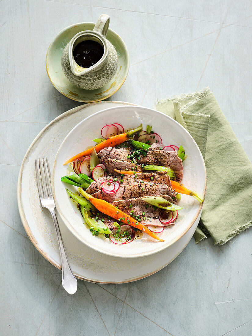 Boiled beef salad with root vegetables, apple and pumpkin seed oil dressing