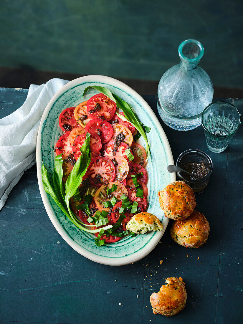 Tomato carpaccio with olive and anchovy dressing and wild garlic scones